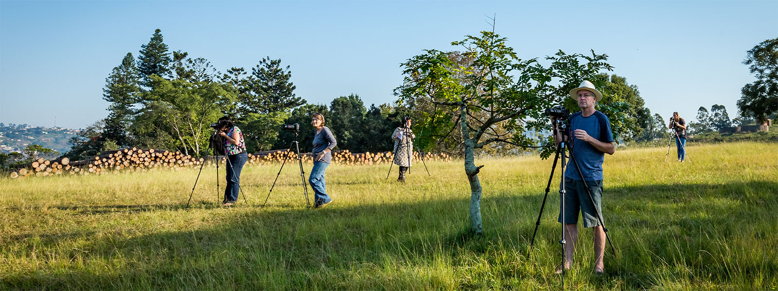 Beginner Photography Students Photography students practising camera settings during a guided outdoor session